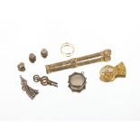 A Victorian yellow metal retracting pencil, inset cornelian; a brooch made from a clock wheel and