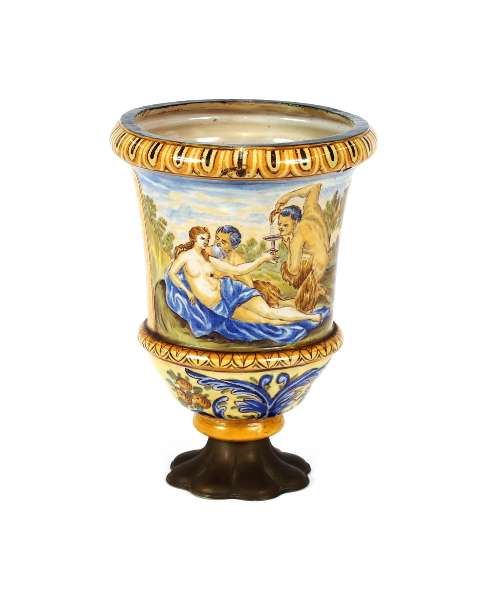 An Antique majolica urn, decorated with classical figures, raised on a later metalware base, 29cm