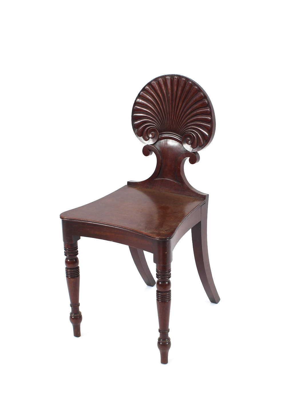 A pair of Regency mahogany hall chairs, having fan shaped backs, raised on ring turned tapering