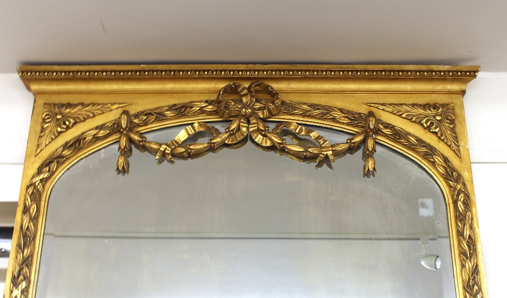A 19th Century French gilt wood pier glass, having arched bevelled rectangular mirrored plate, the