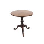 A 19th Century mahogany circular snap top tea table, raised on turned baluster column and tripod