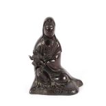 A late 17th / early 18th Century bronze figure, of Guan Yin with infant on her knee, 14cm high