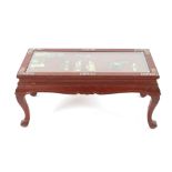 An oriental red lacquered low tea table, inlaid with hardstone figures, horse, clouds and temple,