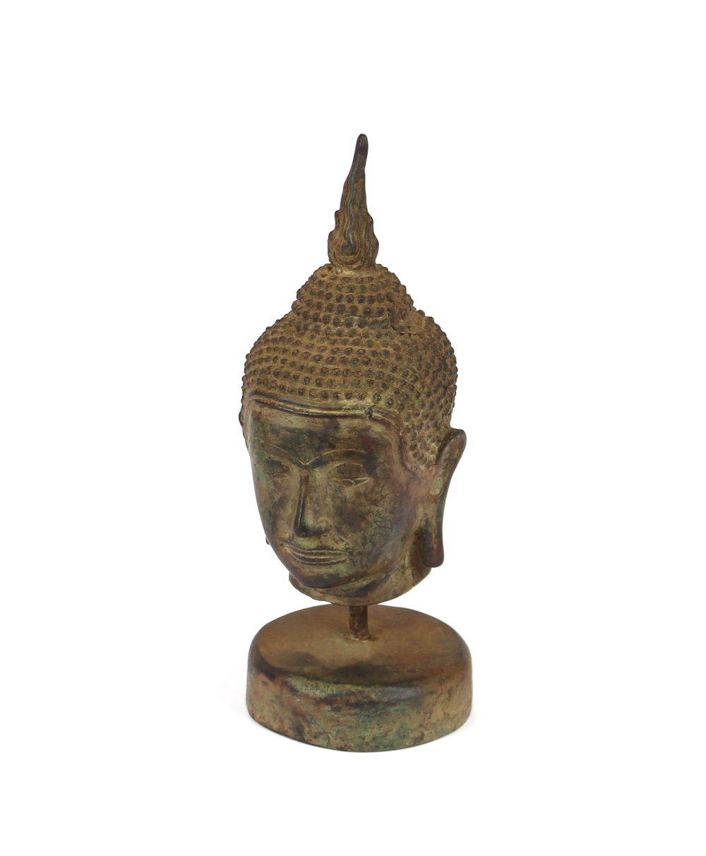Two oriental bronze Buddha heads, 17cm high