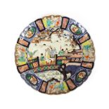 A pair of Japanese Imari scallop bordered plates, decorated figures on a garden terrace, within