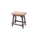 An oak joint stool, raised on turned baluster supports united by stretchers, 43cm wide
