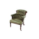 A Victorian walnut tub shaped library chair, upholstered in buttoned green leather raised on