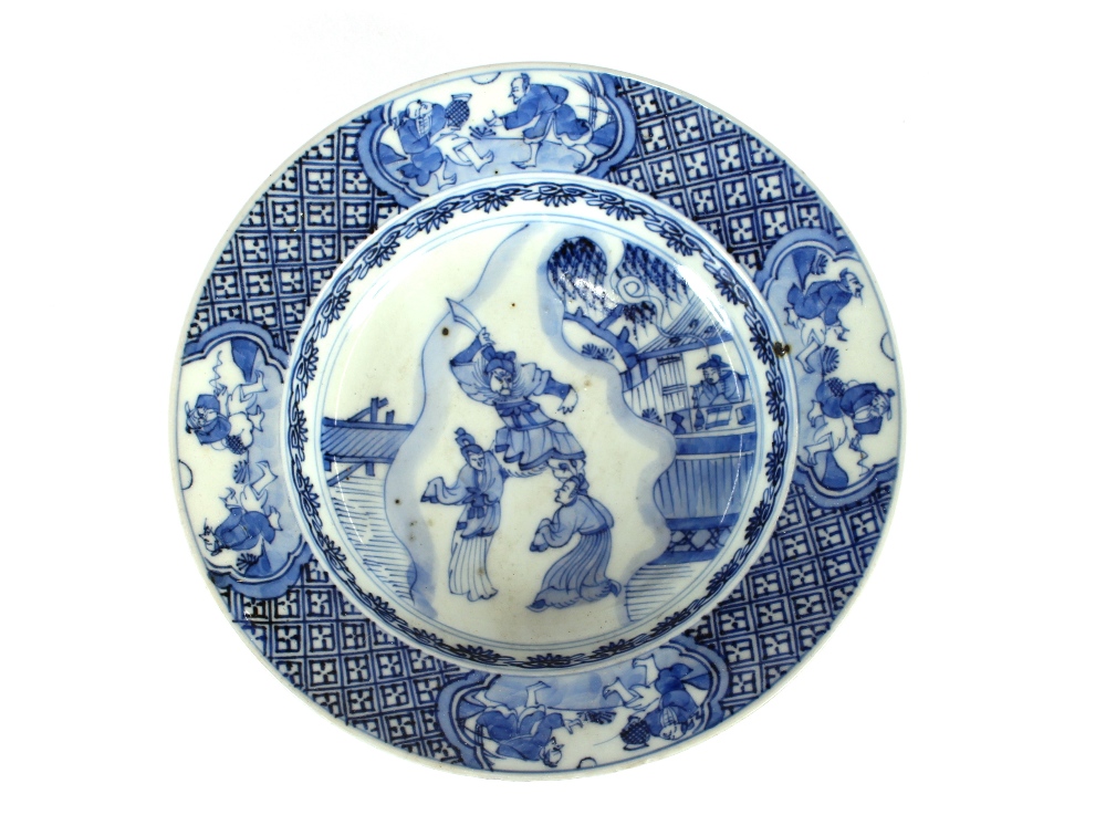 An 18th Century Chinese blue and white shallow dish, decorated with warriors, under-glazed blue leaf