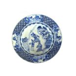 An 18th Century Chinese blue and white shallow dish, decorated with warriors, under-glazed blue leaf