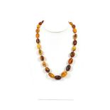 An amber necklace, with yellow metal clasp