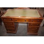 A Victorian oak knee-hole writing desk, having leather inset top, three frieze drawers and six