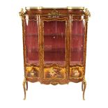 A late 19th Century French rosewood and ormolu mounted serpentine fronted vitrine, inset with Vernis