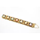 An unusual 18ct gold Japanese Toshikane bracelet, having seven enamelled porcelain panels