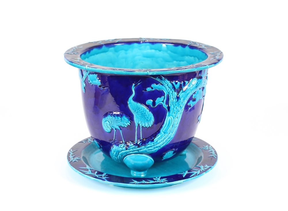 A large Victorian Minton Majolica turquoise jardinière on stand, decorated birds and foliage