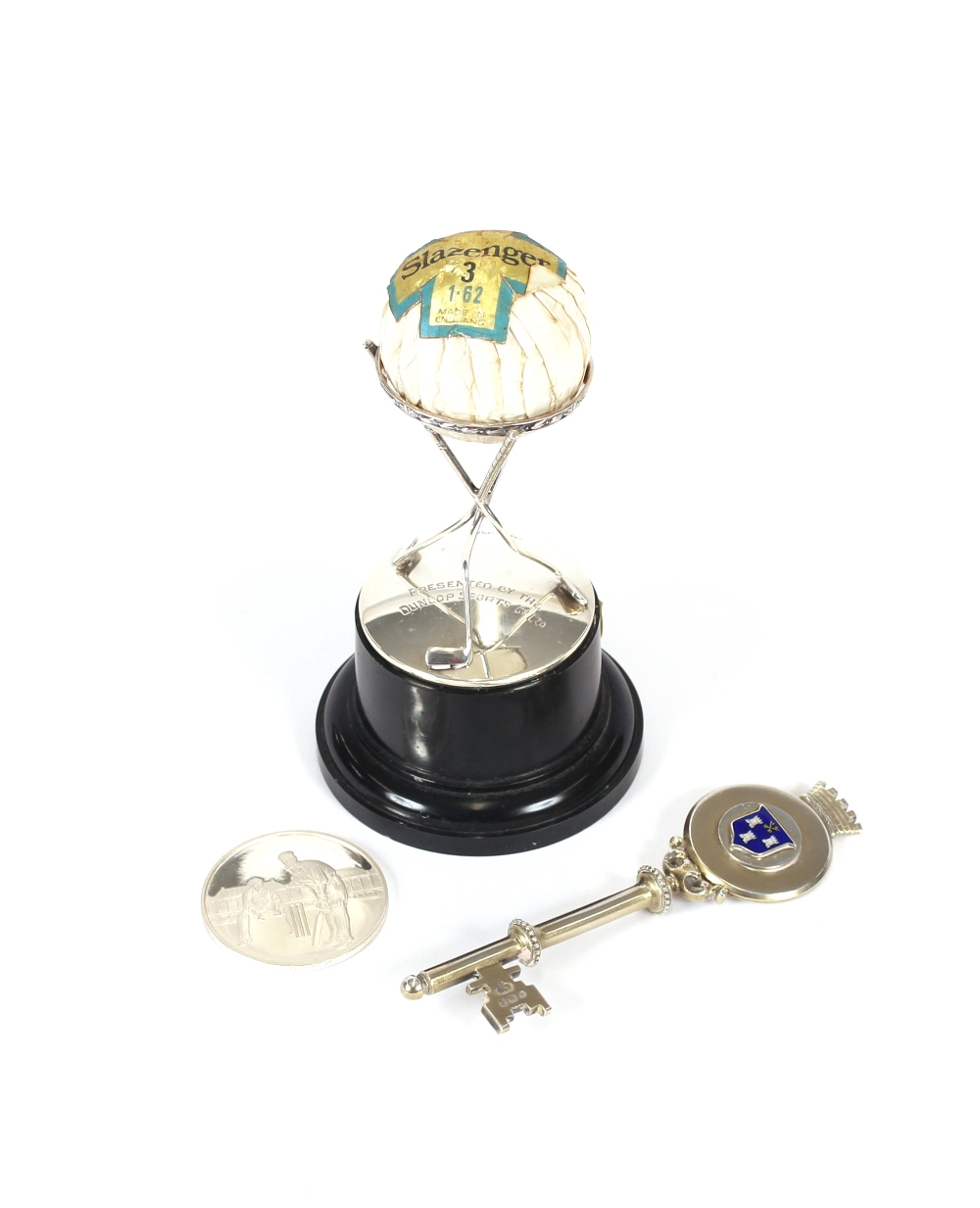 A silver golf trophy, presented by the Dunlop Sports Company Ltd.; a silver Test Cricket centenary