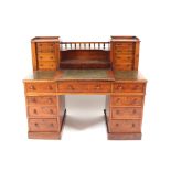 A Victorian walnut pedestal writing desk, the top fitted with a raised bank of 8 small drawers,