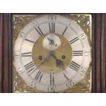 A late 18th Century oak long case clock, the stepped hood enclosing a brass spandriled dial and