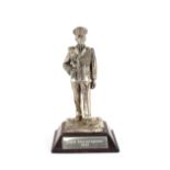 A small white metal statue, depicting Lord Mountbatten in uniform, dated 1945, 9cm high