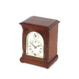 A mahogany cased mantel timepiece, having arched silvered dial, 16.5cm high