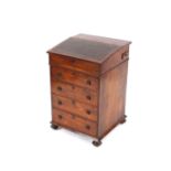 A William IV rosewood swivel top Davenport, fitted four drawers and raised on bun feet, 54cm wide