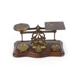 A set of Victorian brass letter scales and weights, with plaque, depicting postal rates
