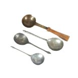 A collection of three pewter spoons, in the 17th Century style with acorn finials; and another