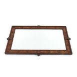 A late 18th/early 19th Century oak and inlaid wall mirror, of oblong form with raised stylised motif