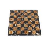 An Italian marble and onyx inlaid chess board, 34cm square