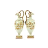 A pair of Grainger & Co., Worcester baluster ewers, rich gilt foliate decoration on pale green