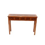 A walnut and cross banded hall table, fitted five short drawers raised on square section chamfered