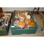 A box containing various storage jars and jugs etc