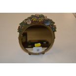 A small circular Barbola easel mirror