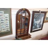 An arch framed sectional mirror