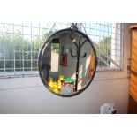 A bevel edged circular wall mirror