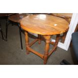 A pine circular topped coffee table