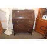 An oak bureau fitted three drawers