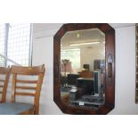 An oak framed bevel edged wall mirror