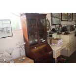 A mahogany bureau bookcase fitted four drawers