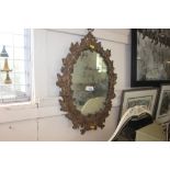 A decorative framed wall mirror (AF)