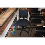 A black upholstered swivel office chair
