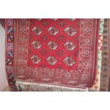 An approx 4'8" x 3'3" red patterned rug