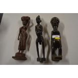 An ethnic carved wooden and beaded figure; and two