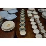 Seven Wedgwood green glazed coffee cans and saucer