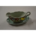 A Clarice Cliff floral decorated sauce boat on sta