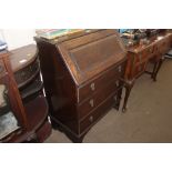 An oak bureau fitted three drawers