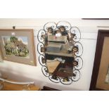 A wrought iron and floral decorated mirror