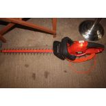 A Black & Decker electric hedge trimmer