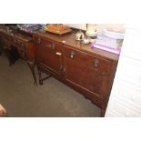 An oak sideboard fitted with drawers