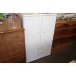 A white melamine tallboy fitted two drawers below