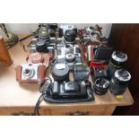 A collection of various cameras to include Olympus